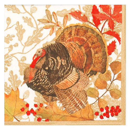 Woodland Turkey Luncheon Napkins. These 3 ply paper napkins feature a white background with a muted light gold edge and pattern of autumn branches framed around a turkey standing over some berries and leaves. Package includes 20 count napkins measuring 6.5in when folded.