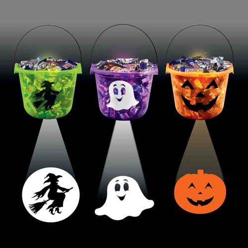 Halloween Projection Bucket. This translucent plastic bucket lights up and projects a character on the ground. Available in green with a witch, purple with a ghost, or orange with a Jack O Lantern. Batteries included. Desired style not guaranteed. Package includes 1 count bucket measuring 8.75in x 6.75in. Candy not included.