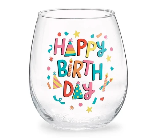 Stemless Wine Glass - Happy Birthday with Party Hats. This wine glass features a decal design of "HAPPY BIRTH DAY" in multicolor text, surrounded by matching confetti, with party hats taking place of the "A's" and a candle in the place of the "I." Measures 4.25in tall with a 2.75in opening, holds up to 16oz. Hand wash only. Arrives in a clear, cylindrical gift box with a pink base and a turquoise bow.