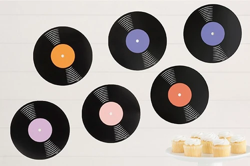 Record Cutouts. These round cardstock cutouts feature black records with labels in orange, reddish orange, purple, light purple, and blush pink. Cupcakes and cupcake stand not included. Package includes 6 count cutouts measuring 9in and 12 count adhesive dots.