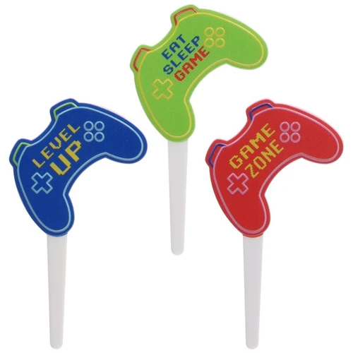 Gaming Controller Cupcake Picks. Each white plastic pick features a gaming controller shape in blue, green, or red, with the phrases "LEVEL UP," "EAT SLEEP GAME," or "GAME ZONE." Package includes 6 count picks measuring 1.65in x 3.15in.