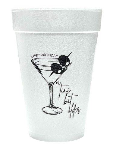 Tini Bit Older Styrofoam Cups - Black. 16 oz white Styrofoam Cups, featuring "HAPPY BIRTHDAY" in small text arched over a martini glass with two olives, and "a Tini bit older" in script to the side, all in black ink pictured on both sides. Each sleeve includes 25 durable cups, perfect for hot or cold drinks at your party.
