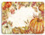 Harvest Plastic Placemat - Pumpkins. With faint script text in the background, this placemat has a border of pumpkins and fall foliage. Desired style not guaranteed. Measures 16in x 12in.