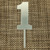 Acrylic Silver Number Cake Topper - 1. These toppers feature a plastic number with a silver finish. Package includes 1 count 4.5in topper.