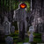 Light Up Flaming Light Pumpkin Man Halloween Decoration. When activated, plastic figure with skeletal hands, draped in gray tattered fabrics and gauze, lights up to reveal a scary Jack O Lantern face, accompanied with creepy sounds. Requires 3 AAA batteries (not included) and assembly. Dimensions: 5ft.