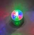 Magic Ball Light Show - On. This spinning faceted piece features red, green, and blue lights, creating a kaleidoscope of color on your ceiling. Requires 3 AA batteries, not included. Base measures about 3.6in in diameter.