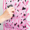 Artist applying POSCA MOP’R marker to a pink patterned fabric surface using drip technique