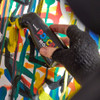 Close-up of artist using POSCA MOP’R marker to add drips on a multicoloured graffiti wall