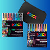 Complete PoscART Travel Art Kit 2 with markers arranged in front of a black POSCA case, set against a bold aqua and purple gradient background.