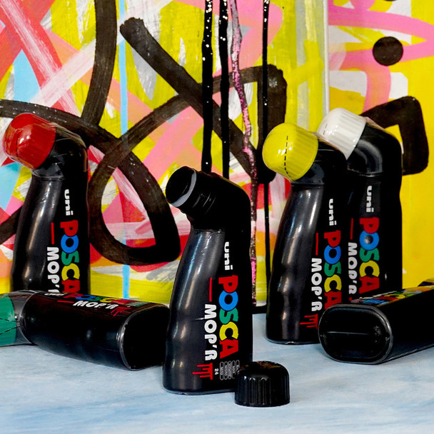 POSCA MOP’R markers standing in front of colourful graffiti backdrop highlighting drips