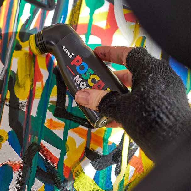 Artist using a POSCA PCM-22 MOP'R Paint Marker to create bold, expressive strokes on a colourful abstract artwork.
