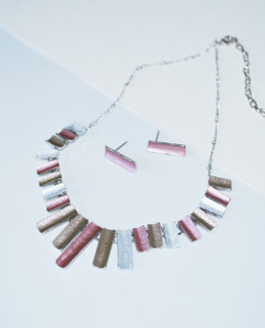 Lagom Bunting Necklace and Earrings Set front view on split paper background Lagom Bunting Necklace and Earrings Set front view on split paper background