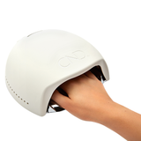 Curing nails under CND LED Lamp during gel polish application
