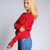 Just Sweatshirts Privé Crewneck Ruby Red sweatshirt, 100% cotton, side rib detail, on a woman.