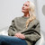 Just Sweatshirts Privé Crewneck in olive sand color, 100% cotton with side rib, worn by a woman.