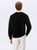 Just Sweatshirts Black crewneck all cotton sweatshirt on a man, showcasing the back of the casual wear.