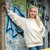 Just Sweatshirts Woman wearing a large white heavy sweatshirt made of natural 100% cotton standing confidently outdoors.