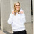 Just Sweatshirts Hooded Pullover White 100% Cotton, a woman wearing a white hooded sweatshirt standing outdoors smiling.
