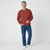 Just Sweatshirts Cranberry red vintage crewneck sweatshirt, 100% cotton, on a man wearing blue jeans and white shoes.