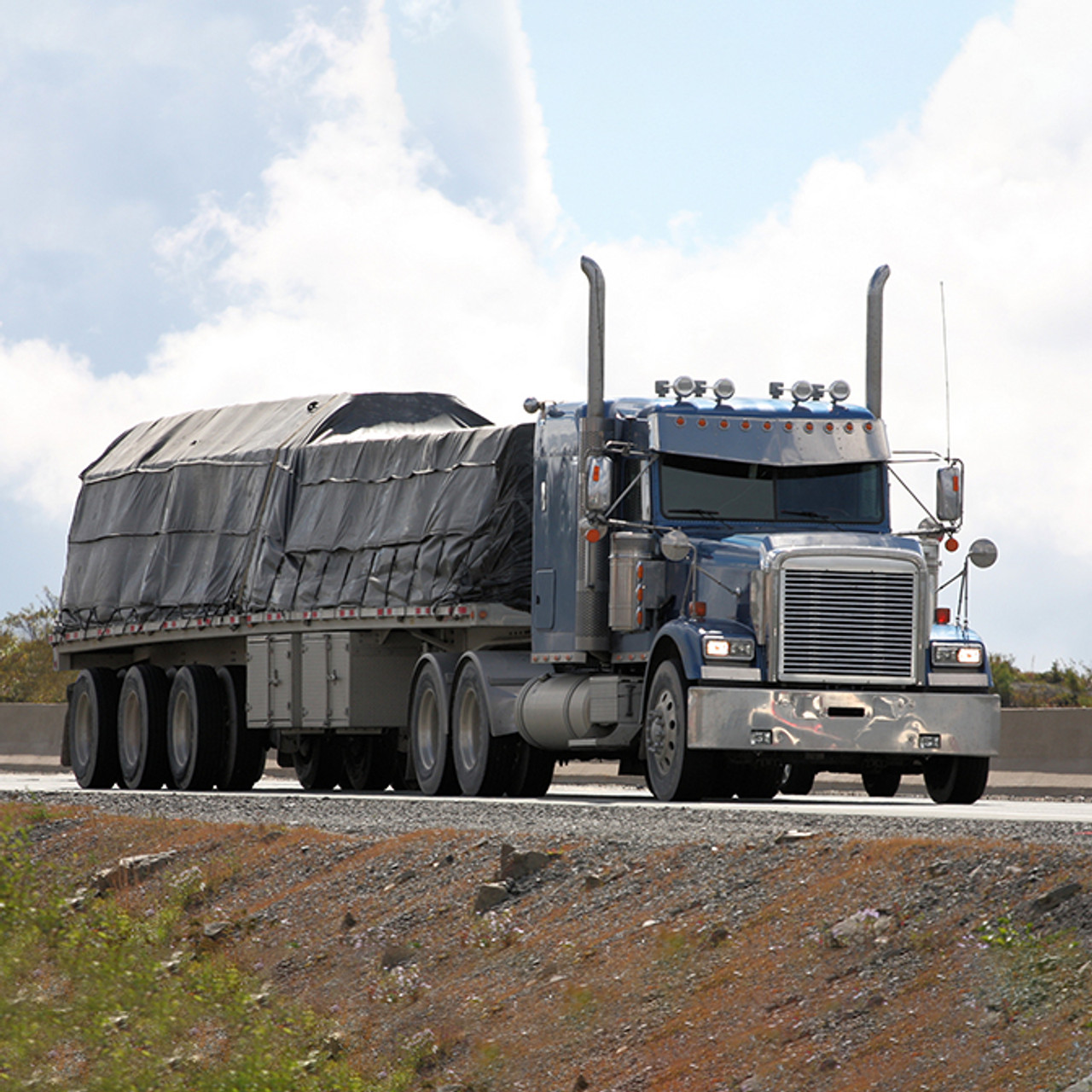 Lumber tarp on semi trailer.