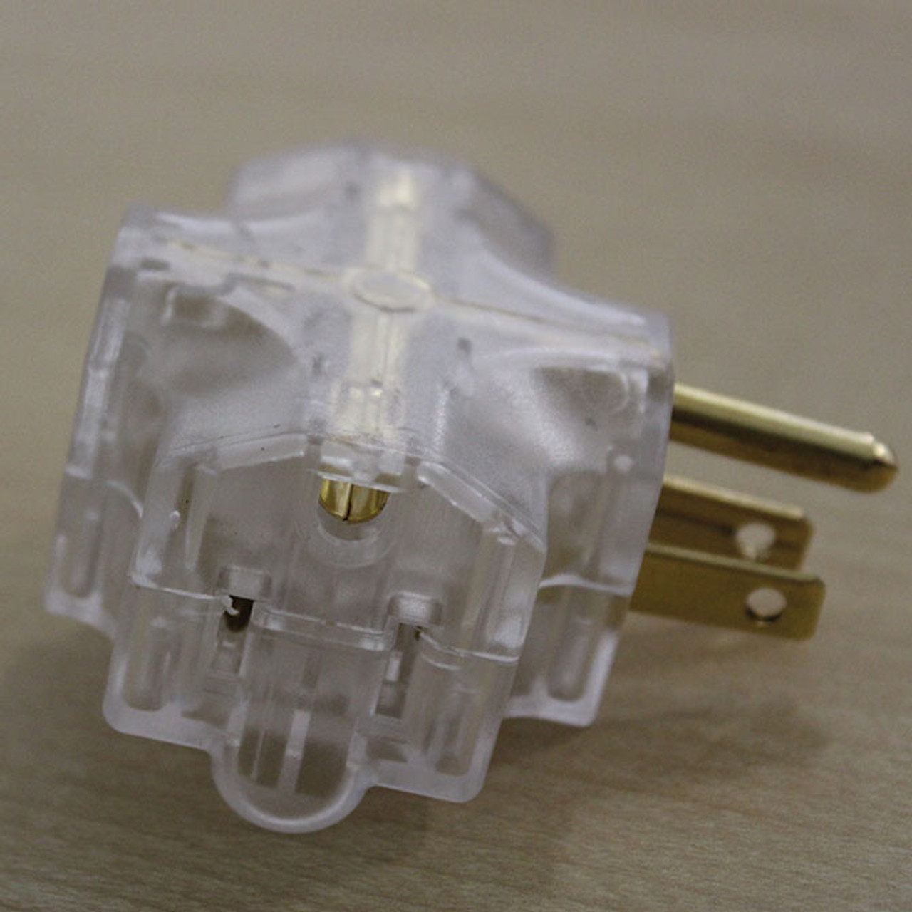 Clear electrical adapter that accepts 3-prong plugs.