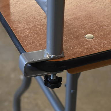 Celina Tent 6' Bar Top for Banquet Tables, close-up view of the corner of a brown bar top with a silver metal support and black adjustable foot.