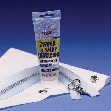 E-Z Zipper & Snap Lubricant, waterproof lubricating gel in a tube with a zipper and snap fastener on fabric.