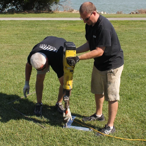 14'' Stake Plate, metal stake plate being installed with electric stake driver.
