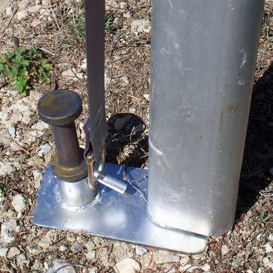 24" x 1" Double Head Tent Stake, image shows a metal stake with a double head mounted on the ground, used for securing outdoor tents.