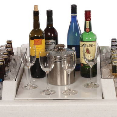 White Little Chiller Insert, product image showing a stainless steel chiller insert placed in the center of a table with various bottles and glasses around it.