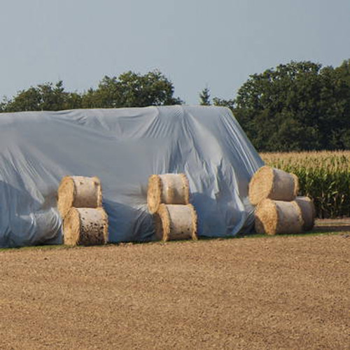 18\'x54\' dual-fabric polyethylene hay tarp protecting the bales of hay underneath. 18\'x54\' dual-fabric polyethylene hay tarp protecting the bales of hay underneath.