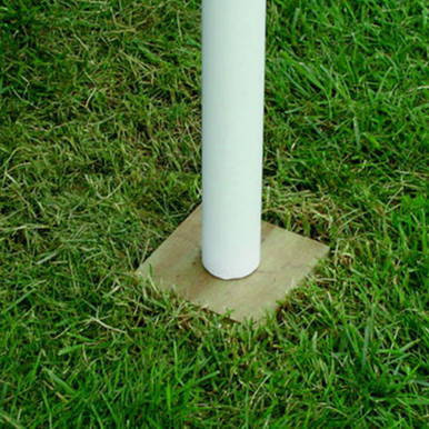 6'' x 6'' Anti-Sink Pole Plate, white pole installed on a concrete base in grass