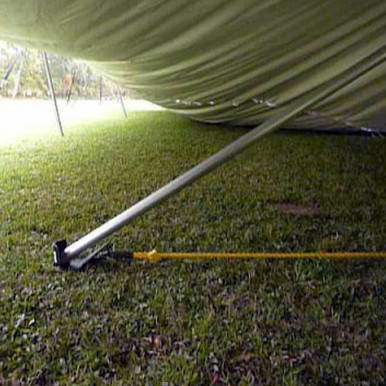 7-inch Raize It! Plate, close-up view of a white 7-inch plate under a tent or canopy on grass, used for outdoor events or activities.