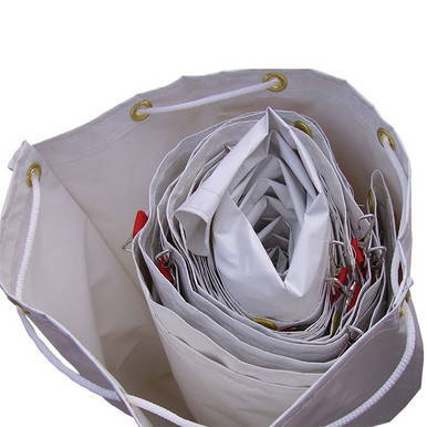 24'' x 34'' Sidewall Bag, interior view showing multiple rolled and folded bags stored inside the large white bag with grommets for easy carrying.