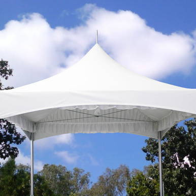 15' x 15' Pinnacle Tent Liner, white tent liner covering the top of a large outdoor tent against a blue sky with clouds.