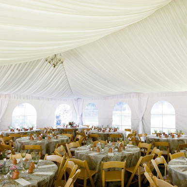 Celina Tent Frame Tent Liner 10' x 5' Mid, interior view of a large event tent with draped ceiling and decorated tables for a wedding or event