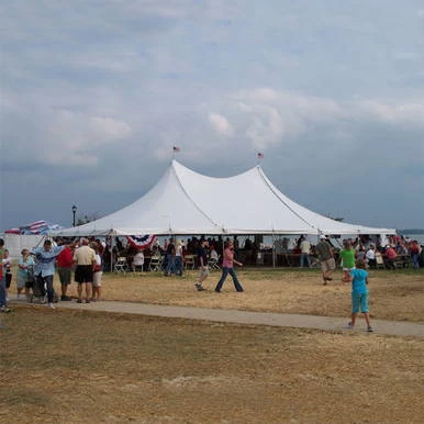 Celina Tent 40' x 60' Premiere I Series High Peak Pole Tent, Sectional Tent Top, Complete, set up at an outdoor event with people gathered underneath and around the tent.