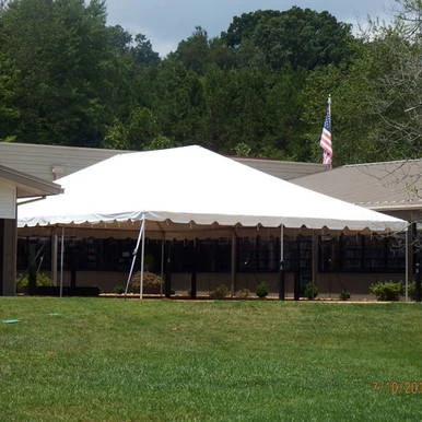 Celina Tent 30' x 45' Classic Series Frame Tent, Sectional Tent Top, Complete, outdoor event tent set up on grass with trees in the background.