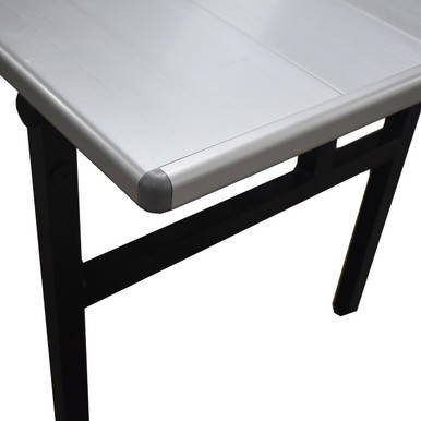 8' x 30" Aluminum Banquet Table, close-up view of the aluminum tabletop with black sturdy legs.