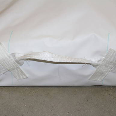 72" x 100" Wrap Around Bag, close-up view of the white fabric bag with a zipper and adjustable straps, suitable for storing and protecting large items.