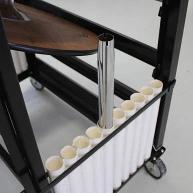 30-inch Pedestal Tables with Cart, showing a black metal cart with ten white pedestal tables and a chrome pole, with cups stored underneath for transport and storage.