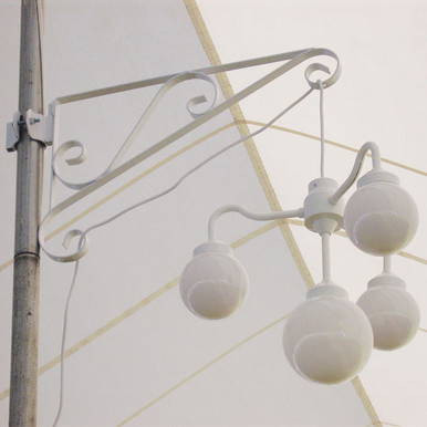 36'' Center Pole Hanger, white decorative pole hanger with now hanging light fixtures against a pale sky background.