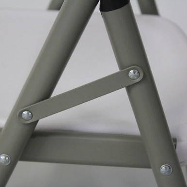 Mayfield Chair and Round Resin Table Set, close-up of the chair's gray metal leg structure with bolts connecting the parts.