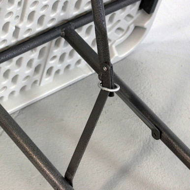 Mayfield Chair and 8' Resin Banquet Table Set, close-up of the chair's black metal leg and support structure showing durability and stability.