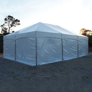 Master Series Winter Package Kit, large white insulated tent set up outdoors with a clear sky and trees in the background.