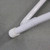 Bellbrook White Poly Chair, close-up of its white polypropylene leg with support bolts on a concrete floor.