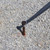 24" x 1" Single Head Tent Stake, metal stake used for securing tents, driven into gravel ground.