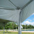 15' Water Gutter for Pinnacle, close-up view of the water gutter system installed under a white canopy with supporting metal poles in the outdoor setting.