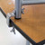 Celina Tent Serpentine Bar Top Outer Edge, close-up image of a round wooden bar top with metal clamps securing the edge.