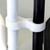 White Poly Chair Ganging Clip, close-up of a white plastic clip securely attaching two chairs' legs together.